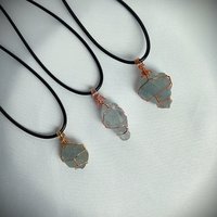 Raw celestite wrapped in gold, rose gold or copper wire with cord.