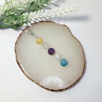 Depression pendant with citrine, rose quartz, amethyst, moonstone, aquamarine and chain or cord.