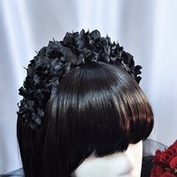 Headband with silver spikes and black flowers.