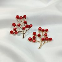 Gold branch charms with red faux pearl beads.