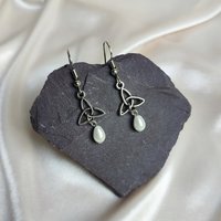 Celtic trinity knot dangle earrings with faux pearl beads.