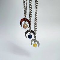 Silver moon pendant with gemstone beads.