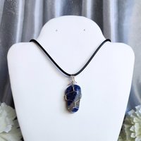 Sodalite wire wrapped pendant in silver.