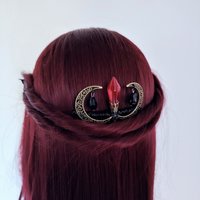 Gothic comb with bronze moons, red crystal and black beads.