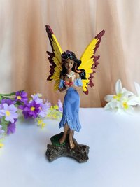 Custom hand painted fairy figurine with purple dress and yellow wings.