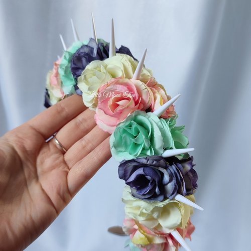 Bella unicorn headband with white spikes and pastel flowers in pink, green, purple and white.