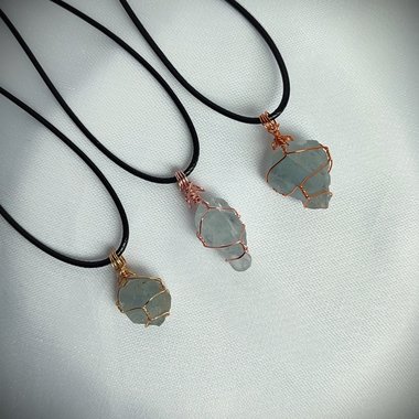 Raw celestite wrapped in gold, rose gold or copper wire with cord.