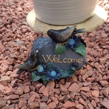 Gothic welcome plaque with black birds and flowers.