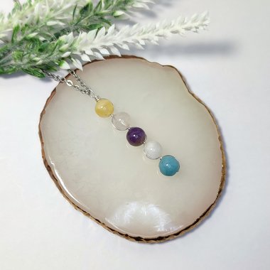 Depression pendant with citrine, rose quartz, amethyst, moonstone, aquamarine and chain or cord.