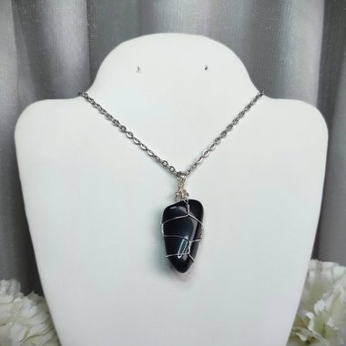 Obsidian wire wrapped pendant in silver with chain or cord.