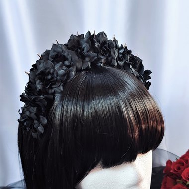 Headband with silver spikes and black flowers.