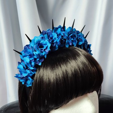 Bella Blue Headband with blue faux flowers and black spikes.