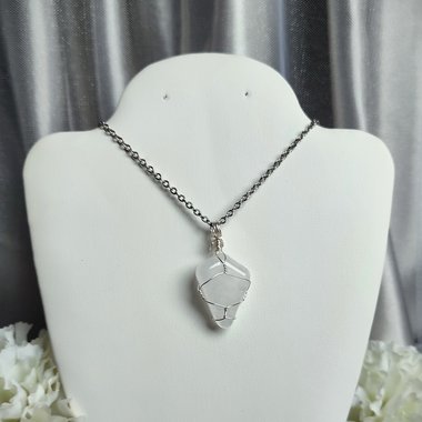 Clear quartz pendant wrapped in silver plated wire with chain or cord.