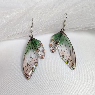 Fairy dangle earrings with clear and green resin fairy wings, glitter and diamantes. 