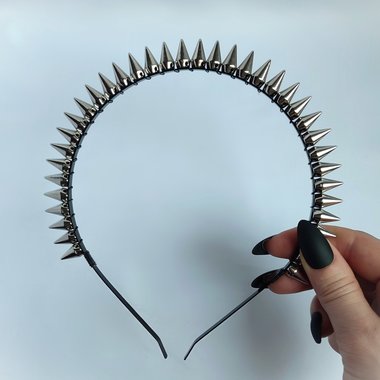 Studded headband with silver spikes wire wrapped onto a black headband.