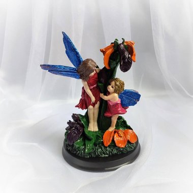 Mother and child woodland fairy statue on wooden base.