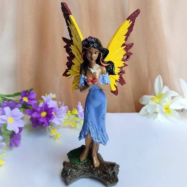 Custom hand painted fairy figurine with purple dress and yellow wings.