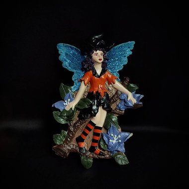 Hanging witch fairy repainted in durable acrylics.